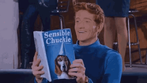 a man in a blue shirt is holding a magazine called sensible chuckle