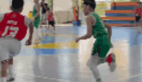 a blurred image of a basketball game with a player wearing a number 13 jersey