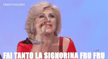 a woman in a red dress is covering her nose with her hand and the words fai tanto la signorina fru fru are above her