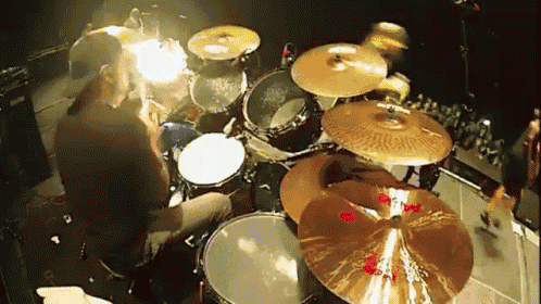 a drummer is playing a set of zildjian cymbals on a stage