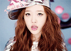 a woman with long hair wearing a hat with horses on it