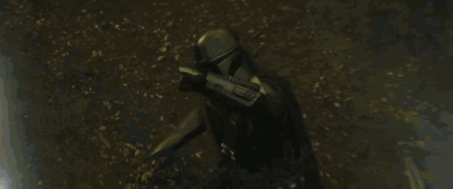 a man and a woman are standing next to each other holding lightsabers .