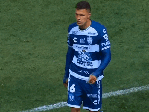 a soccer player wearing a blue shirt that says telcel