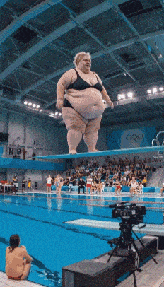 a woman in a bikini is standing on a diving board in a pool