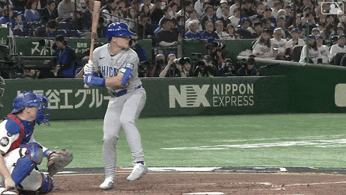 a baseball player in a chicago uniform is about to swing his bat