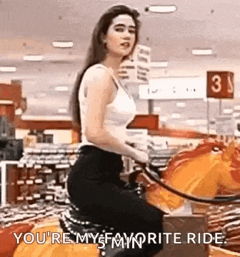 a woman is riding a motorcycle in a store and says `` you 're my favorite ride '' .