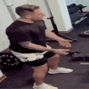 a man is squatting on a bench in a gym .