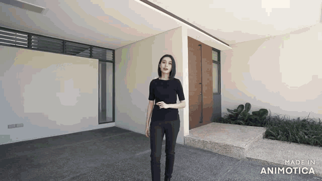 a woman in a black shirt is standing in front of a building made in animatica