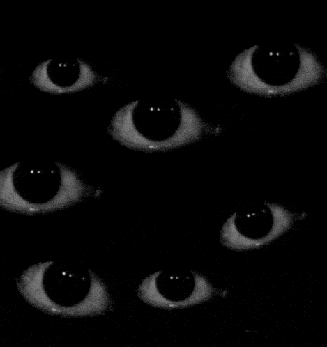 a bunch of eyes are stacked on top of each other in the dark