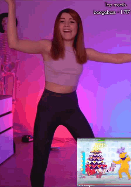 a woman is dancing in front of a screen that says top month bcogeboss - 1717