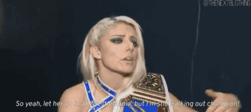 a female wrestler is holding a wrestling championship belt and talking to someone .