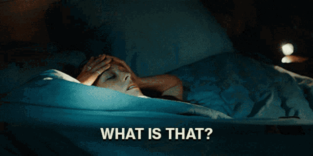a man laying in bed with his hand on his forehead and the words what is that