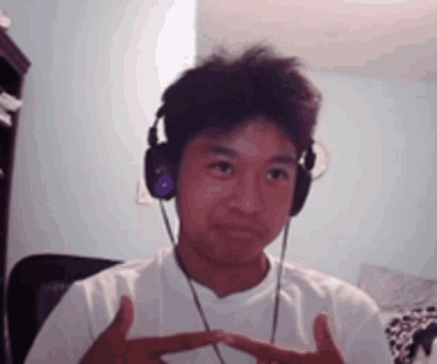 a man wearing headphones and a white shirt
