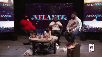 a group of men sit in front of a screen that says atlanta