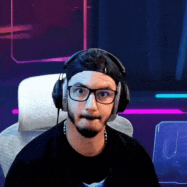 a man wearing headphones and glasses is making a face