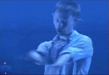 a close up of a man 's face in a blue room