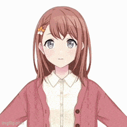 a girl with a flower in her hair is wearing a pink cardigan and a white shirt .