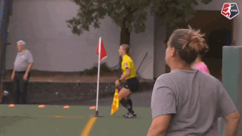 a group of people are playing a game of soccer with a nysl logo on the bottom right