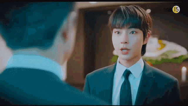a man in a suit and tie is talking to another man in a suit and tie .