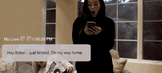 a woman looking at her phone with a message that says hey babe