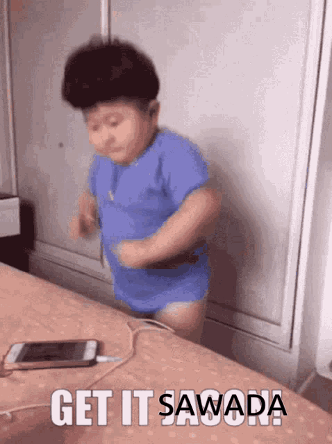 a little boy in a blue shirt is dancing on a bed with the words get it sawada written above him