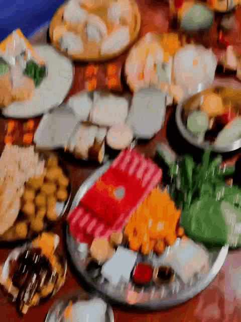 a table topped with plates of food including a red wallet