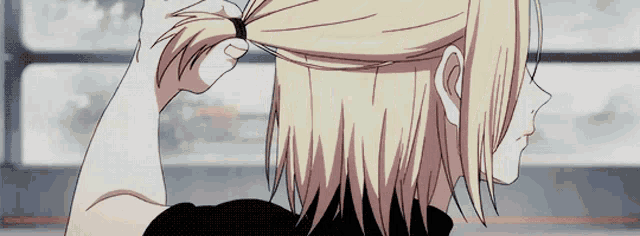 a person is tying their hair in a ponytail