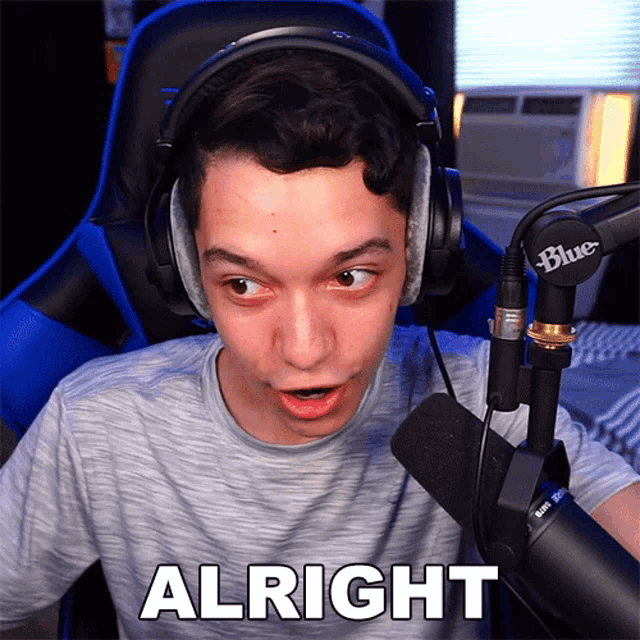 a man wearing headphones and a microphone says " alright "