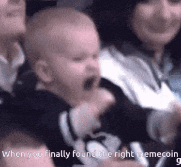 a baby is screaming in a crowd with the caption when you finally found the right memecoin