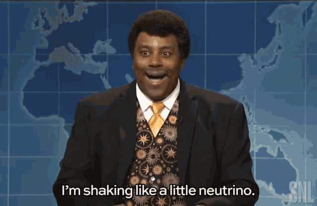 a man in a suit and tie says i 'm shaking like a little neutron