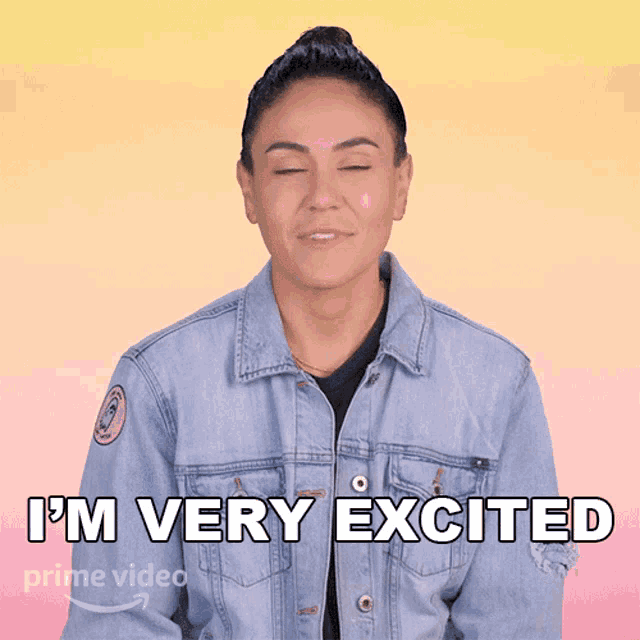 a woman wearing a blue denim jacket says i 'm very excited