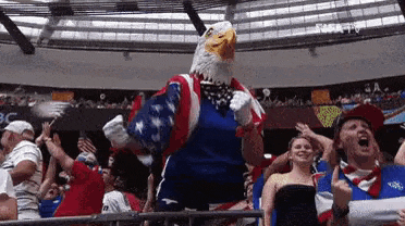 a man in a bald eagle costume is dancing in front of a crowd of people