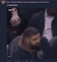 a blurry picture of a man in a suit sitting in a chair
