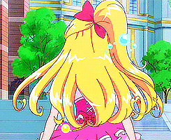 a girl with long blonde hair and a red bow on her head