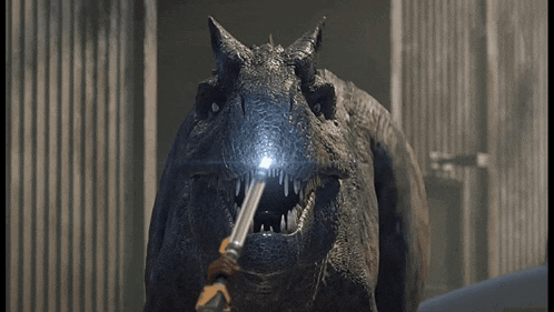 a close up of a dinosaur holding a light in its mouth