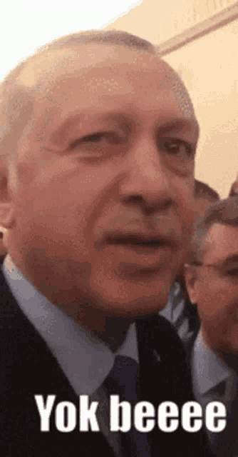 a close up of a man 's face with the words yok beeee written on it