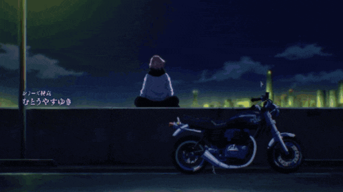 a person sits on a wall next to a motorcycle with chinese writing