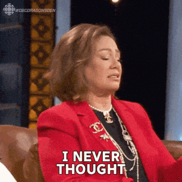 a woman in a red jacket is sitting on a couch and says i never thought