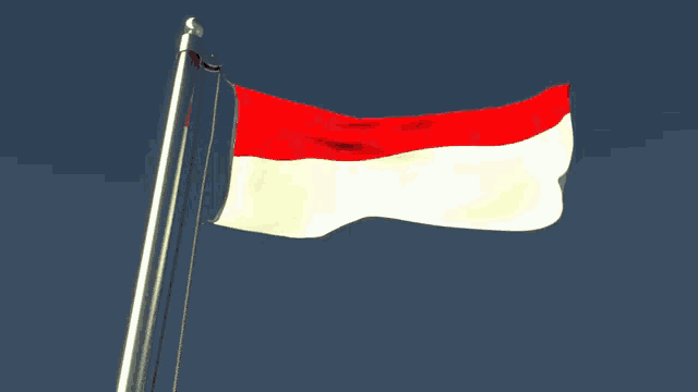 a red and white flag is waving in the wind against a blue sky