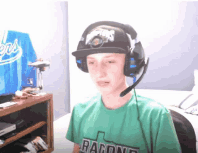 a boy wearing headphones and a green shirt that says ragione