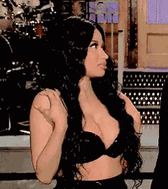 a woman in a black bra is standing on a stage