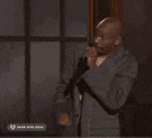 a man singing into a microphone with the word better on the bottom