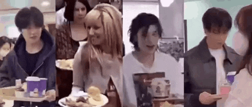a group of people standing next to each other in a restaurant holding trays of food .