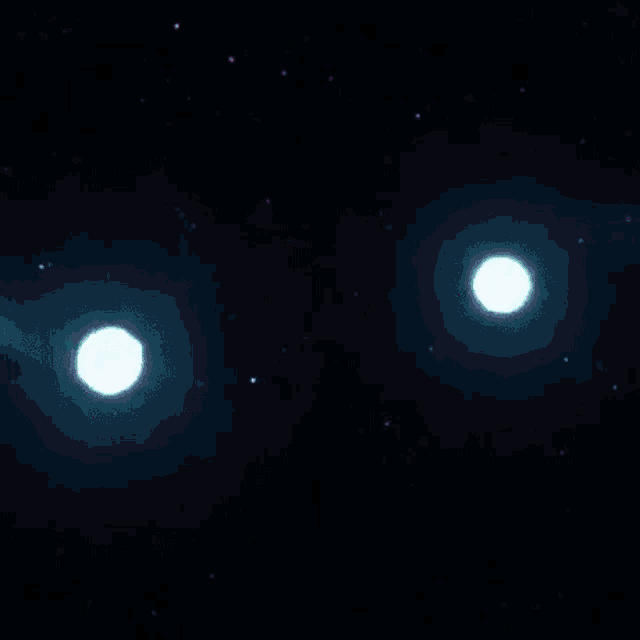 a close up of two lights in a dark room