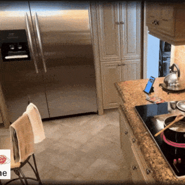 a kitchen with a stainless steel refrigerator and a stove top oven