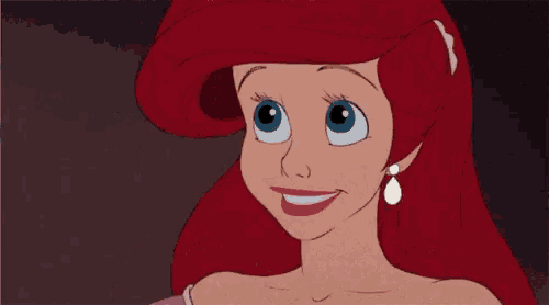 ariel from the little mermaid is wearing a pink dress and earrings and smiling .