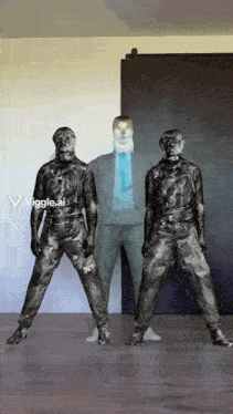 a man in a suit and tie is standing next to two other men who are covered in black paint