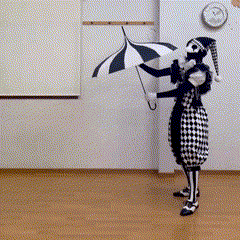 a clown is holding an umbrella in front of a clock