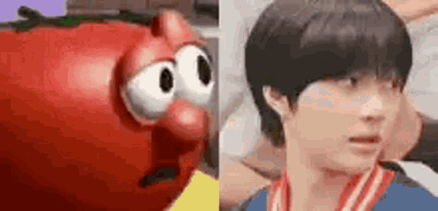 a cartoon tomato with big eyes is next to a young man with short hair .