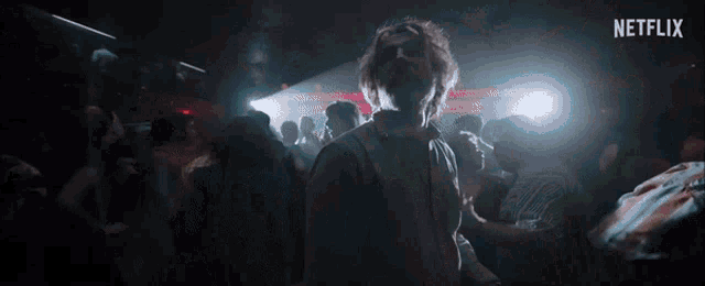 a man is dancing in a crowded room with netflix written on the bottom